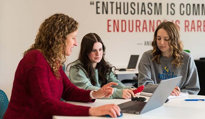 Engineering students and professor working on the trachea 3D printing project in the Innovation Annex.
