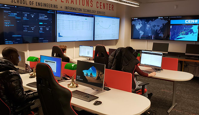 Students sitting at desks in the School of Engineering's Security Operations Center, participating in a simulated cyberattack.