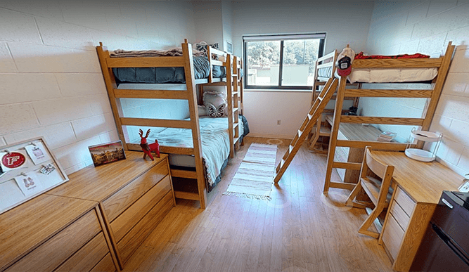 Virtual 3D scan of a 70 McCormick triple dorm room with bunk beds against one wall and a lofted bed on the other, designed to house three students.