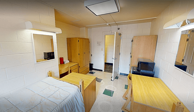 Virtual 3D scan of a Jogues Hall double dorm room with beds, desks, and wardrobes against opposite walls, designed to house two students.