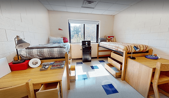 Virtual 3D scan of a Regis Hall double dorm room with beds against opposite walls, designed to house two students.