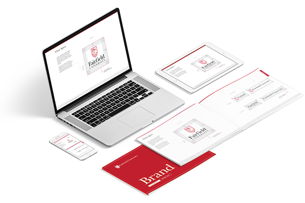 A labtop, mobile phone, and hand book showcasing Fairfield University branding.