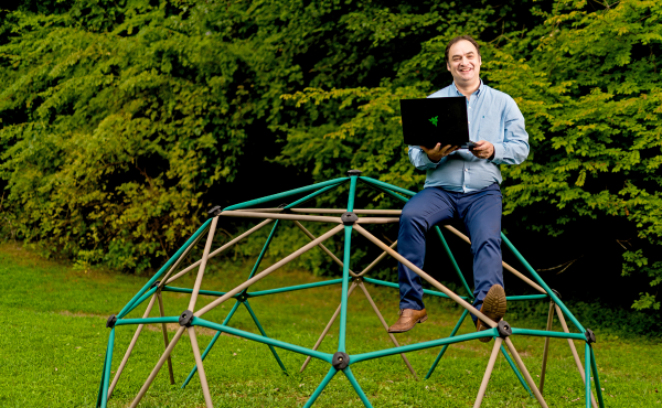 Dr. Philip Maymin balances on a jungle-gym in the yard of his Greenwich, Conn. home