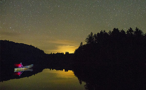 A canoeist heads out to stargaze in the Adirondacks.