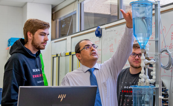 Naser Haghbin, PhD, professor of the practice in mechanical engineering, conducts lab work with Maksymilian Puk ’24; Since 2020, the University has launched 25 online master’s degree programs and graduate certificates