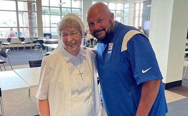 Sister Carol Ann Nawracaj OSF, M’77 and current N.Y. Giants Head Coach Brian Daboll at last year’s pre-season training camp.