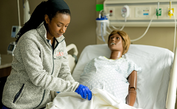 Fairfield Nursing student practicing a medical simulation in a hospital setting.