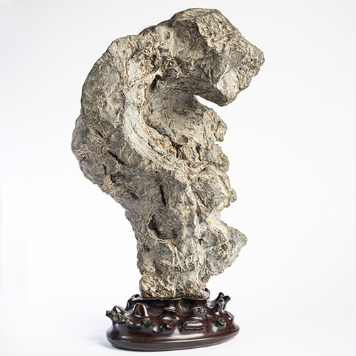 Scholar’s rock, ca. 18th century, stone, wood base. Lent by Jane and Leopold Swergold