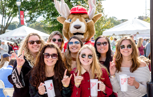 A group of students standing with the Stag mascot posing for a picture
