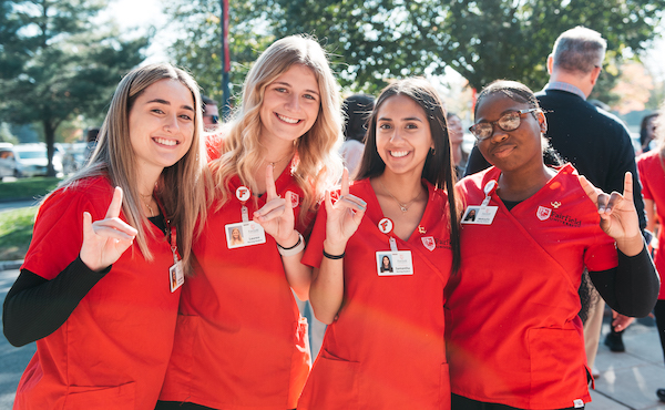 A group of four Fairfield University nursing students standing next to each other.