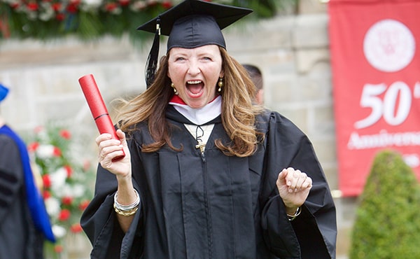 An excited student receives her degree at Fairfield University's 66th commencement ceremonies on Sunday, May 22; Credit: Gwen Pellegrino