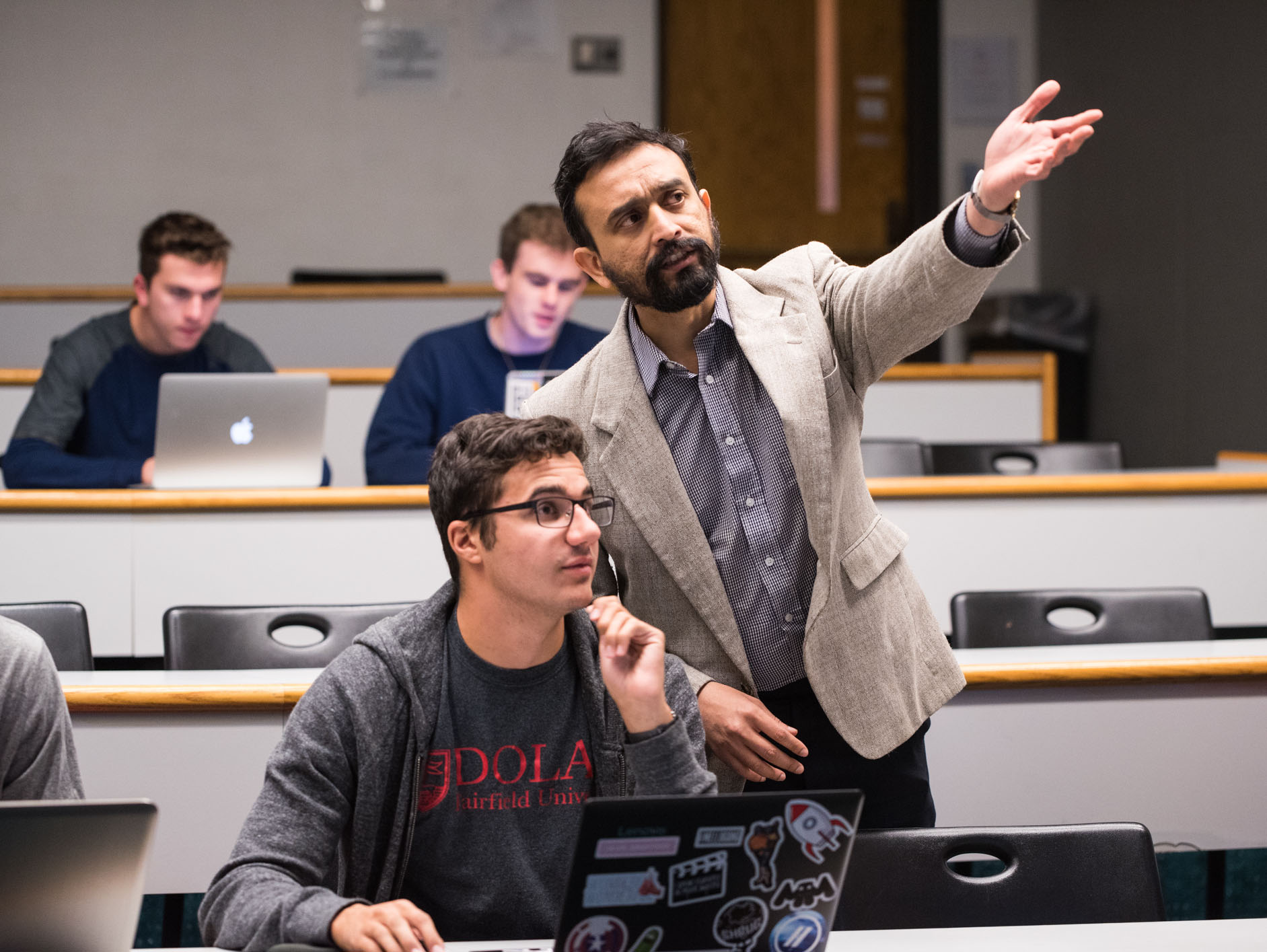 A student in Fairfield University's nationally ranked Dolan School of Business Master of Science in Business Analytics program gets valuable information from a professor.