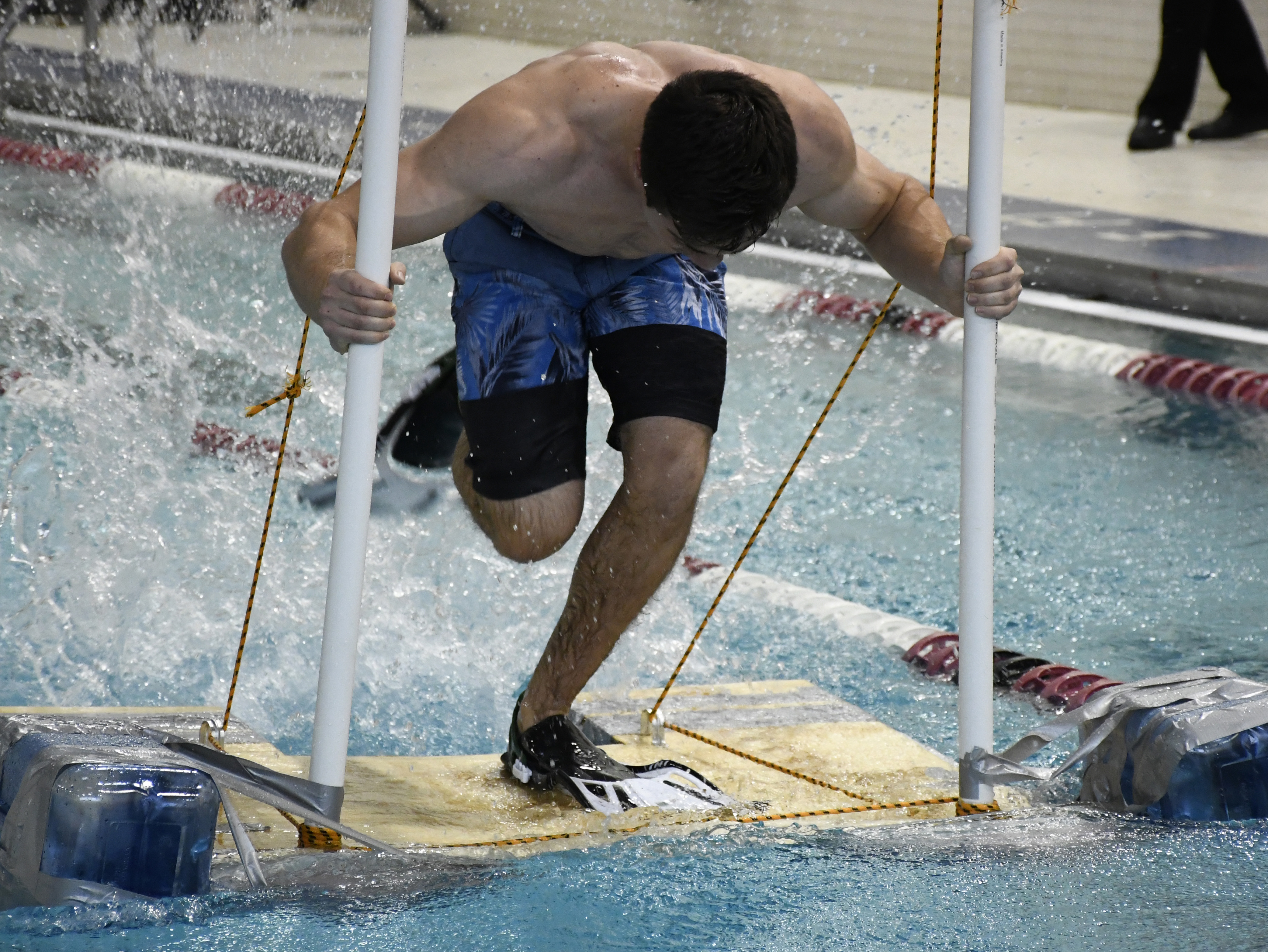 student operating a device to cross the pool