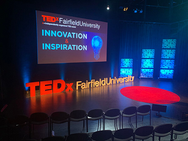 TEDxFairfieldUniversity logo and lightbulb graphic