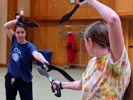 Students practice stage combat during rehearsals.