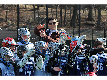 Connecticut Hammerheads midfielder Landon Kramer posing with local youth lacrosse players