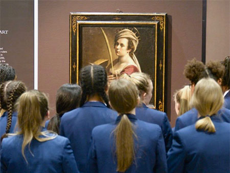 Students admire Artemisia Gentileschi, Self-Portrait as Saint Catherine of Alexandria (circa 1615-17). 