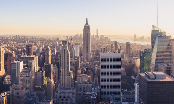 A stock photo of New York city skyline featuring the Empire state and Chrysler buildings