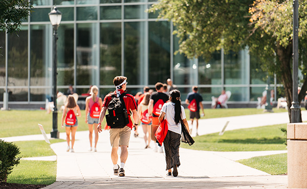 A bright and sunny day on Fairfield campus, showing students walking through the quad.