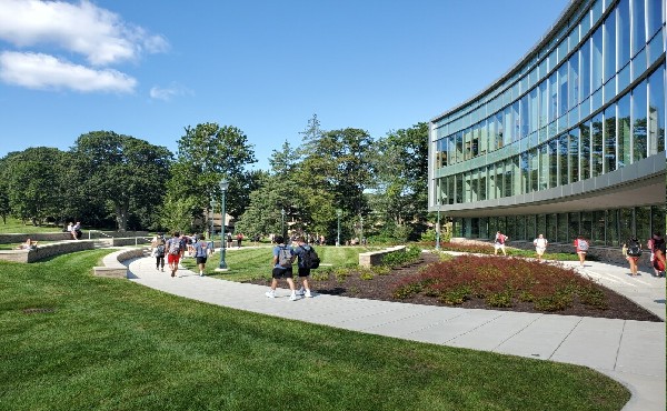Image of students walking in front of the Dolan School building