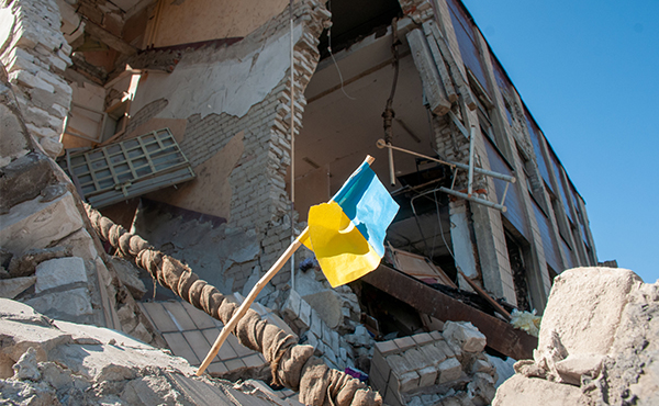 Flag of Ukraine on ruins of a school in Kharkiv, Ukraine