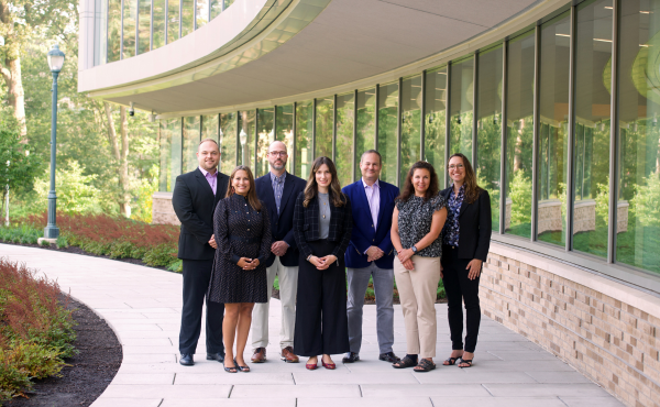First Executive Doctorate of Business Administration (Executive DBA) cohort in front of the Charles F. Dolan School of Business. 