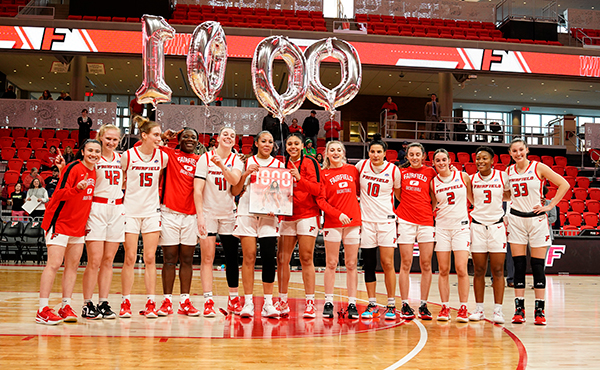Callie Cavanaugh '21 and her teammates celebrate her 1,000th career point after their Jan. 7 victory over Manhattan.