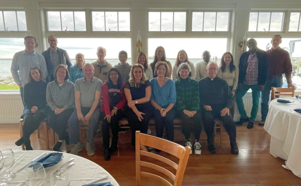 Large group photo of SEHD faculty posing at the faculty retreat.