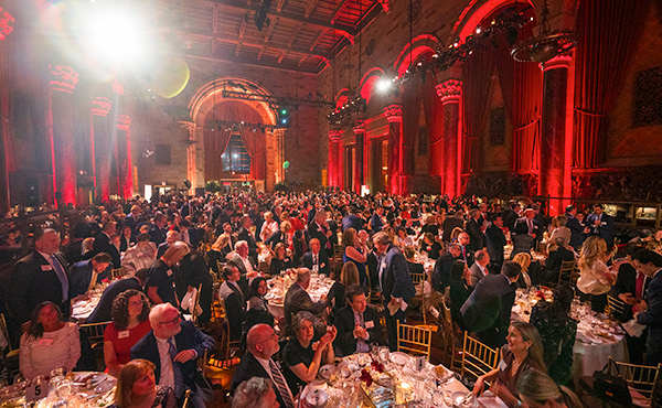 Wide angle image that shows more than 700 alumni, parents, students, and friends of Fairfield sitting at dinner tables at Cipriani 42nd Street in New York City for Awards Dinner event. 