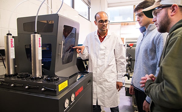 Engineering professor and students using the new 3D printer, Rapida Conflux.