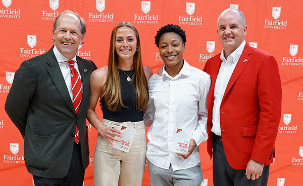 President Mark R. Nemec, PhD, and Vice President for Athletics Paul Schlickmann with the 2023-24 Women's co-Athletes of the Year, Elizabeth Talluto and Janelle Brown
