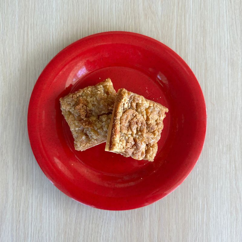 A plate with two slices of apple streusel pizza