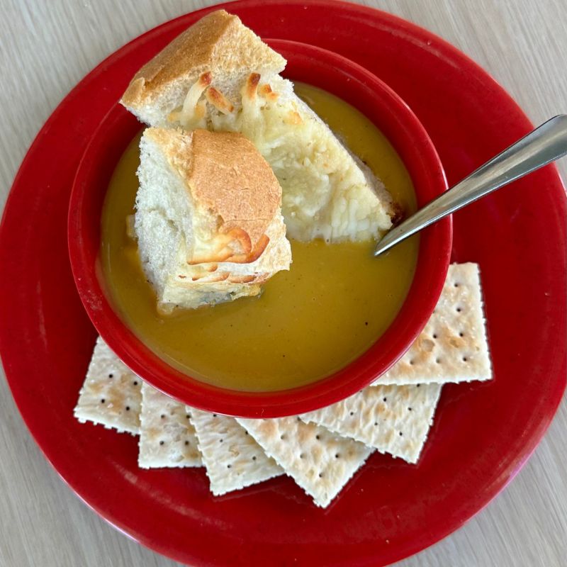 Bowl of soup with dipping bread and crackers